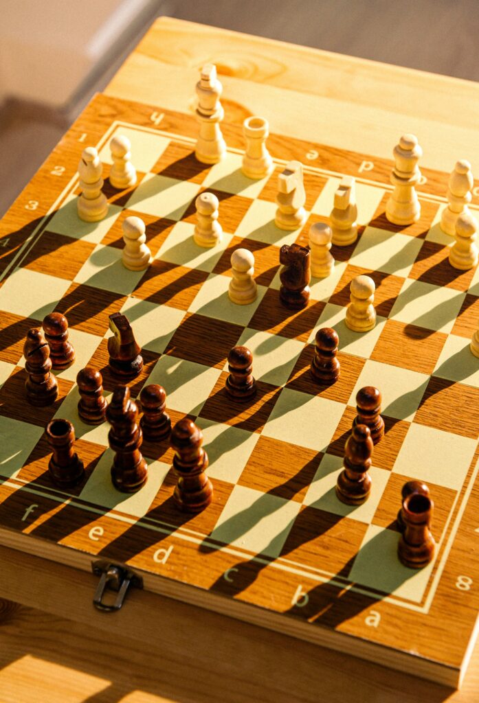 Wooden chess board with a game in progress.